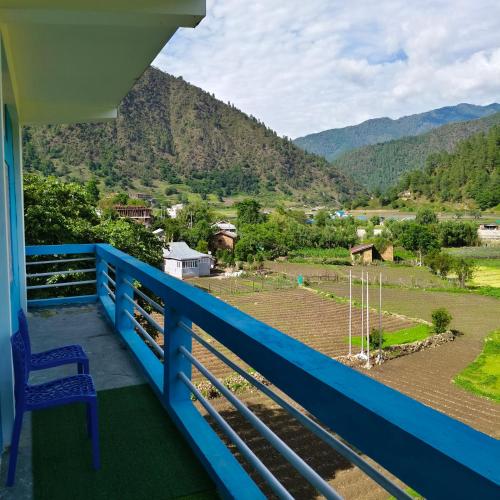 a blue balcony with a view of a mountain at Valley View Homestay in Dirang Dzong