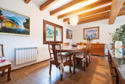a dining room with a table and chairs at Hall of The Mountain Pool - Bunyola in Bunyola