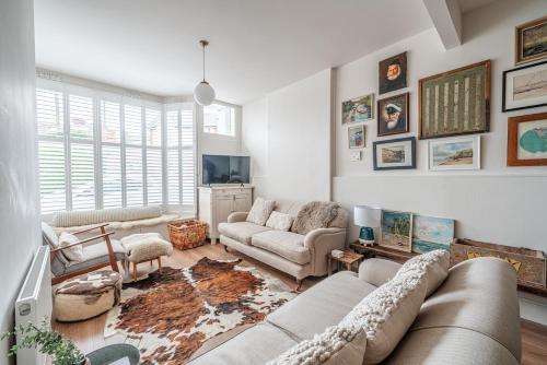 a living room with a couch and a tv at The Beach House in Melcombe Regis