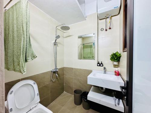 a bathroom with a toilet and a sink at Vietnam Travelers Home 2 with Cozy Private Balcony in Hanoi