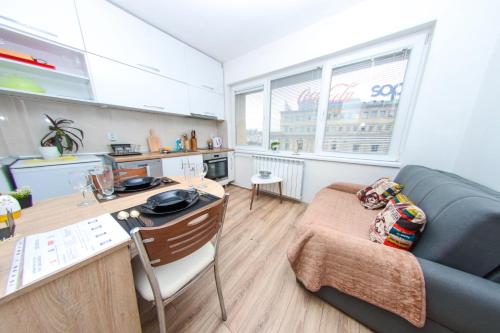 a living room with a couch and a table at Exclusive Apartment Main Square FREE PARKING in Skopje