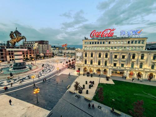a view of a city with a cocacola sign on a building at Fantazy Apartment Main Square in Skopje