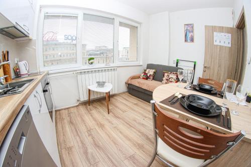 a small kitchen and living room with a couch at Fantazy Apartment Main Square in Skopje