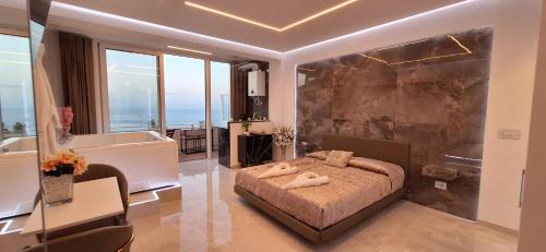 a bedroom with a bed and a bath room with a tub at Suite Imperial in Taormina