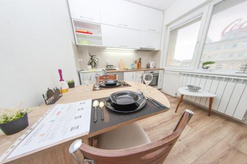 a kitchen with a table with dishes on it at Mother Teresa Apartments in Skopje