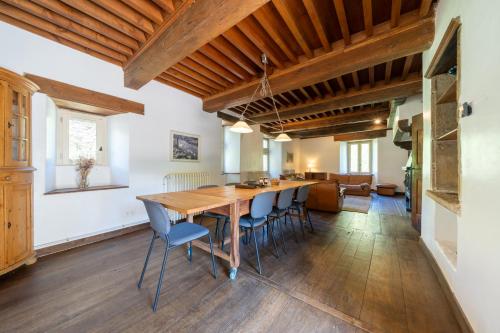 a large dining room with a wooden table and chairs at Château de Salamon - plage privée in Réquista