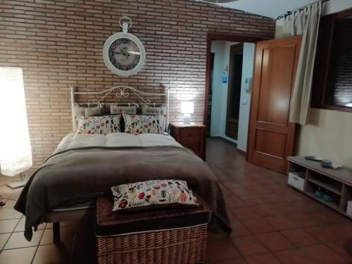 エル・プエルト・デ・サンタマリアにあるÁtico Vicario 11のレンガの壁のベッドルーム1室(大型ベッド1台付)