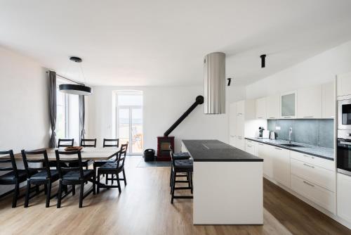a kitchen and dining room with a table and chairs at Vacov Apartment in Vacov