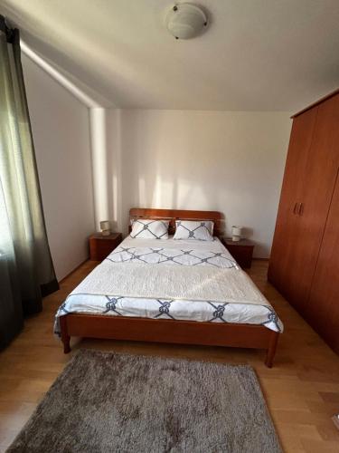 a bedroom with a bed and a rug at Apartment Dalmare in Biograd na Moru