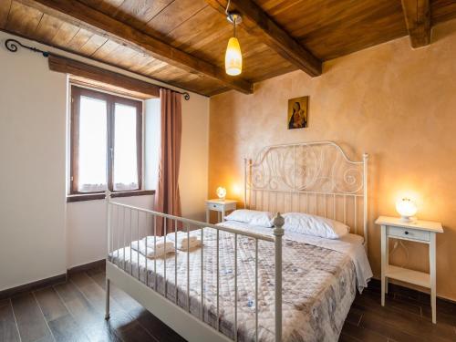 a bedroom with a bed and a window at Beautiful Apartment in Sestino with Garden in Sestino