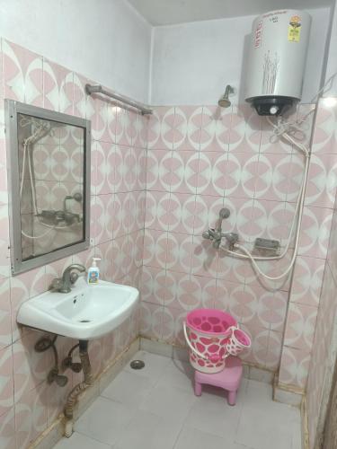 a bathroom with a sink and a mirror at Hotel Aditya Palace in Rānchī