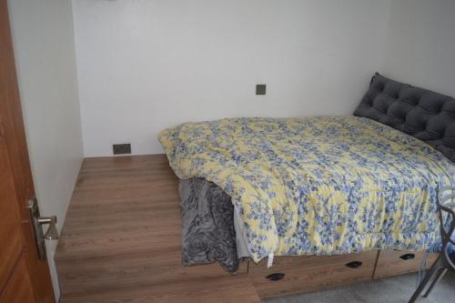 a bedroom with a bed with a blanket on it at Christian home retreat in Ngong
