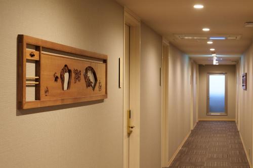 a hallway with a long corridor with a hallway at Waqoo Shitaderamachi in Osaka