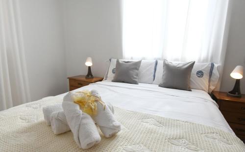 a bedroom with a bed with towels on it at Casa Cancela Combarro in Pontevedra