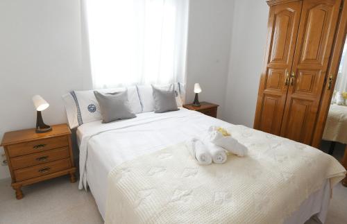 a bedroom with a bed with two stuffed animals on it at Casa Cancela Combarro in Pontevedra