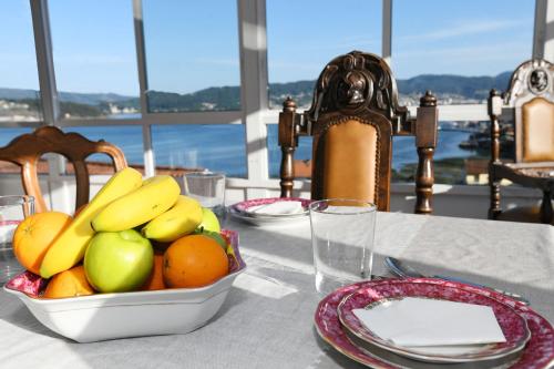 a table with a bowl of fruit on top of it at Casa Cancela Combarro in Pontevedra