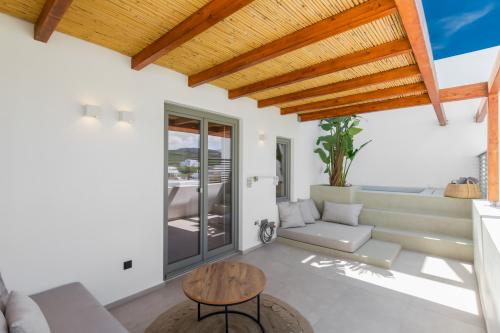 a living room with a couch and a table at Clementina Paros in Naousa