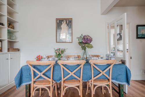 a dining room table with chairs and a blue table cloth at The Beach House in Melcombe Regis