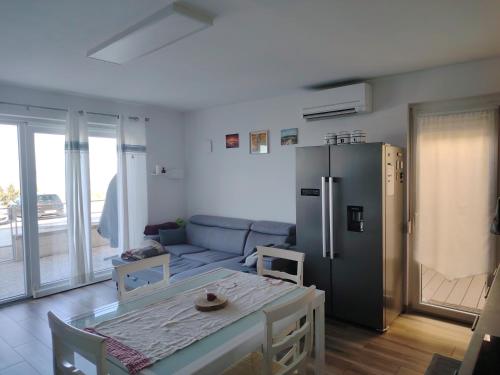 a living room with a couch and a refrigerator at Vivere in Slovenia in Plavje