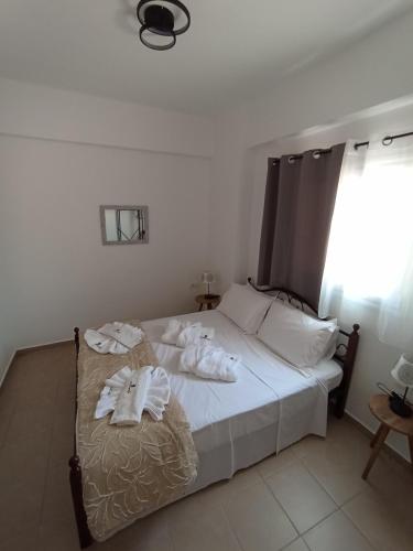 a bedroom with a bed with towels on it at ARTEMIS beach studios in Kalamaki Heraklion