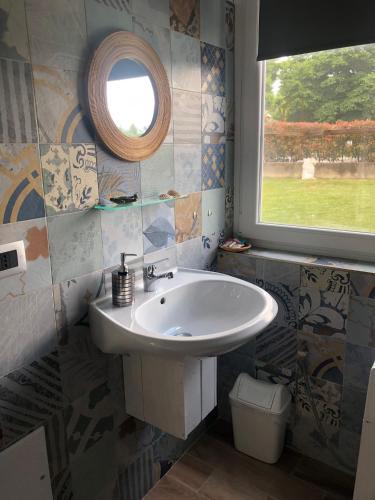 a bathroom with a sink and a window at La Casa di Manu in Lessona