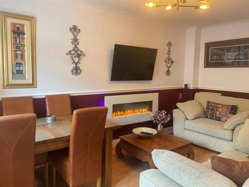 a living room with a table and a fireplace at Cosy Retreat - house with double bedroom in Ripon