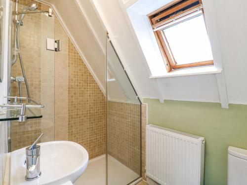 a bathroom with a sink and a window at Kingfisher in Ely