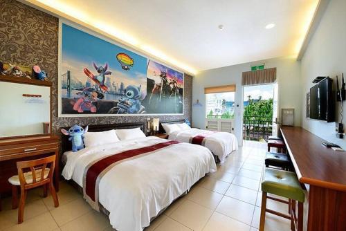 a hotel room with two beds and a flat screen tv at Jinge Guest House 集集金格民宿電動車充電站 in Jiji