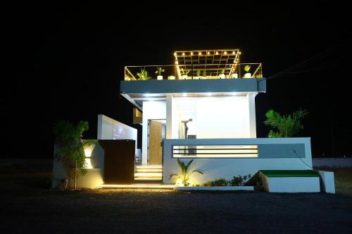 a lit up building with a balcony at night at Sun Splash Villa in Chīrāla