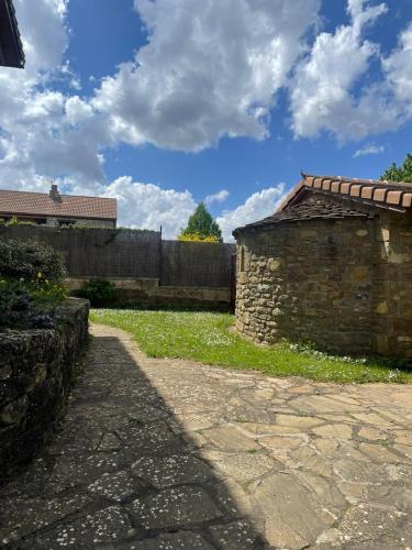 a stone building sitting next to a brick wall at Hotel Barosse in Jaca