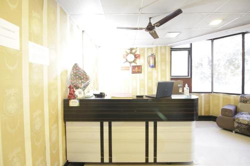 an office with a desk with a laptop on it at Hotel Satyam Swagat in Jawālāpur