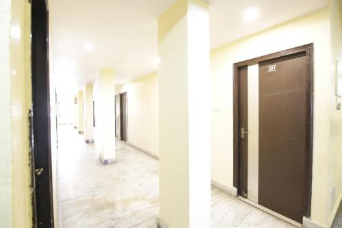 an empty hallway with a door in a building at Hotel Satyam Swagat in Jawālāpur