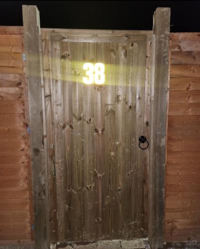 a wooden door with the number on it at Twin Room in Crawley,Gatwick,West Sussex in Ifield