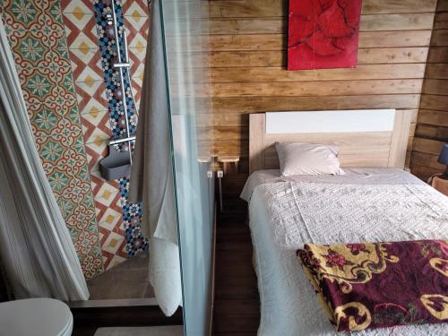a small bedroom with a bed in a room at The Vie Llage - Authorial Suites Bungalows in Vagos