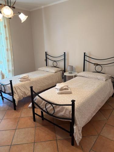 two beds sitting next to each other in a room at La Brentella in Arzergrande