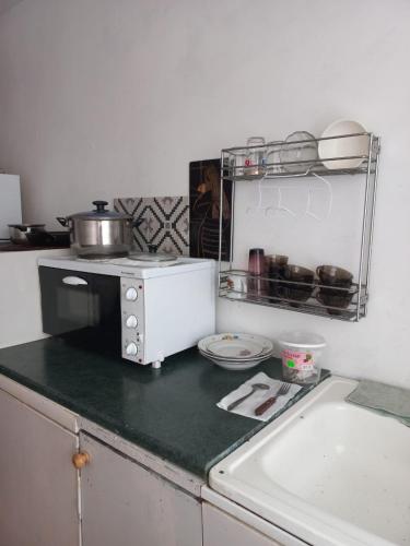 a kitchen with a counter top with a microwave at Private room at 2 km from Airport in Tallinn