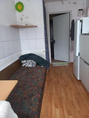 a room with a bed in the middle of a kitchen at Private room at 2 km from Airport in Tallinn