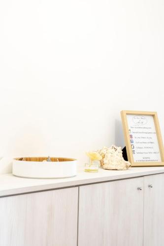 a white cabinet with a plate on top of it at La Casa Bianca by M&G in Orero