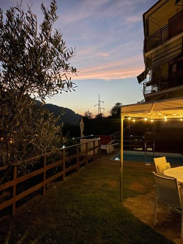 a patio with a table and a umbrella and a building at La Casa Bianca by M&G in Orero