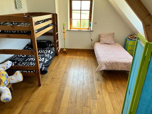 une chambre avec deux lits superposés et un lit dans l'établissement Albizia, à Sainte-Geneviève