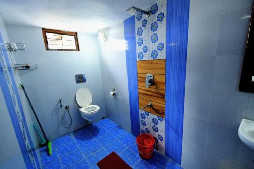 a bathroom with a shower and a toilet and a sink at Beena Homestay in Fort Kochi