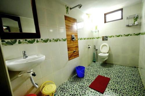 a bathroom with a sink and a toilet at Beena Homestay in Fort Kochi