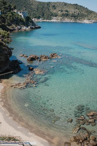 an aerial view of a beach with blue water at Hotel Ficocella in Palinuro