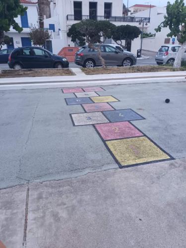 a street with colorful squares on the road at Vrontas House in Neapolis