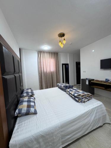a bedroom with a large bed with pillows on it at Camel Dive Club By The Sea Inn in Jurf ad Darāwīsh