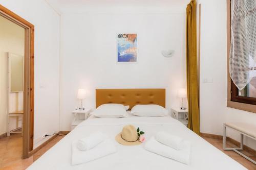 une chambre avec un lit avec un chapeau dessus dans l'établissement Le 3 Pièces de la Vieille Ville, à Menton