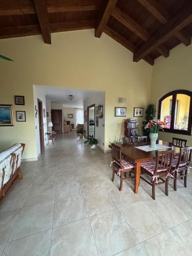 a large living room with a table and chairs at Ca Belvedere in Follo Alto