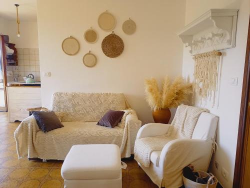 a living room with two chairs and a couch at Casa Artigena in Rapallo