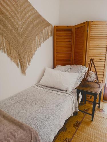 a bedroom with a bed and a chair and a table at Casa Artigena in Rapallo