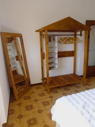 a room with a bed and a table and a mirror at Casa Artigena in Rapallo
